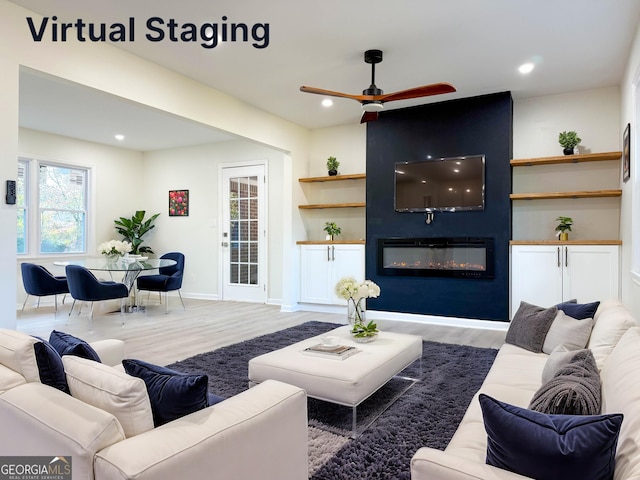 living area with ceiling fan, a large fireplace, wood finished floors, and recessed lighting