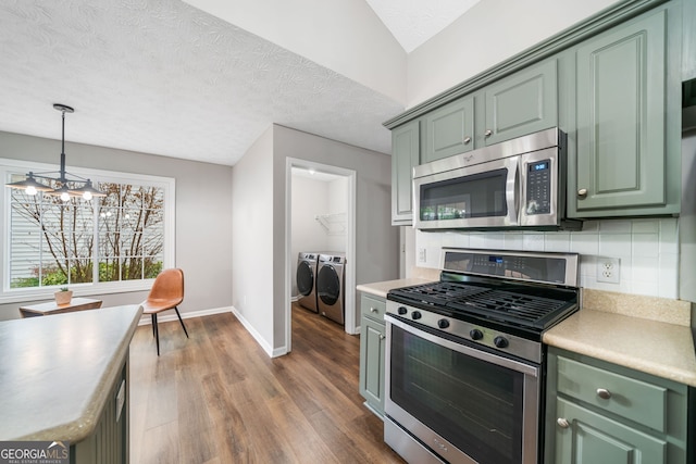 455 Ellesmere Way, Buford, GA 30518 - kitchen featuring green cabinets, wood finished floors, washing machine and clothes dryer, and stainless steel appliances