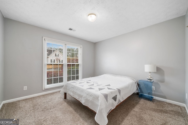 455 Ellesmere Way, Buford, GA 30518 - carpeted bedroom featuring baseboards, visible vents, and a textured ceiling