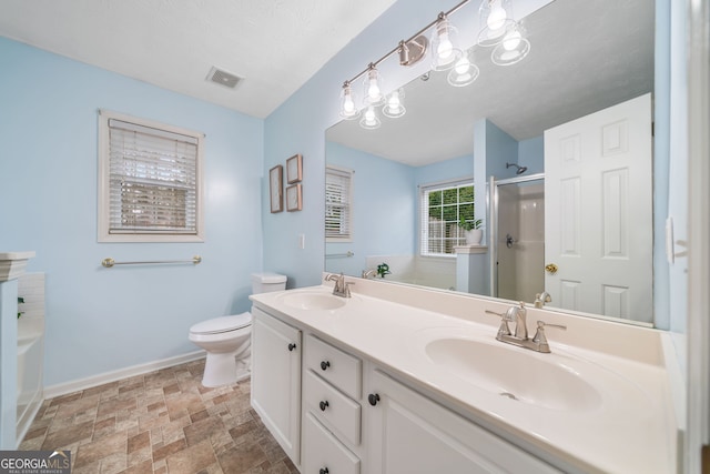 455 Ellesmere Way, Buford, GA 30518 - full bathroom with a sink, stone finish floor, an enclosed shower, and visible vents