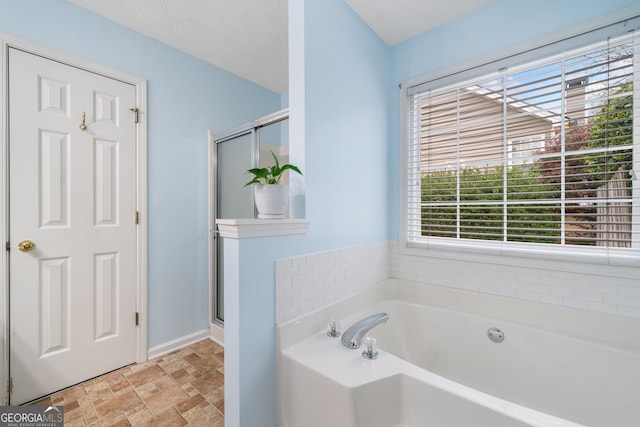 455 Ellesmere Way, Buford, GA 30518 - bathroom with a bath, a shower stall, and stone finish flooring