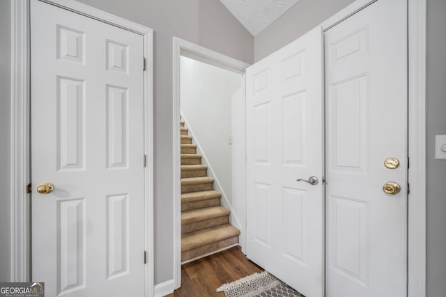 455 Ellesmere Way, Buford, GA 30518 - stairs featuring vaulted ceiling, wood finished floors, and a textured ceiling