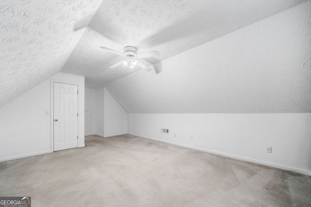 455 Ellesmere Way, Buford, GA 30518 - bonus room with vaulted ceiling, a textured ceiling, baseboards, light colored carpet, and ceiling fan