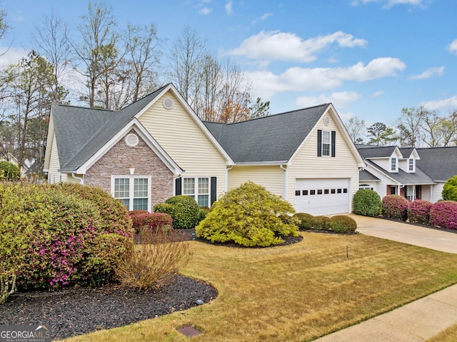 455 Ellesmere Way, Buford, GA 30518 - traditional-style house with stone siding, an attached garage, concrete driveway, a front yard, and a shingled roof