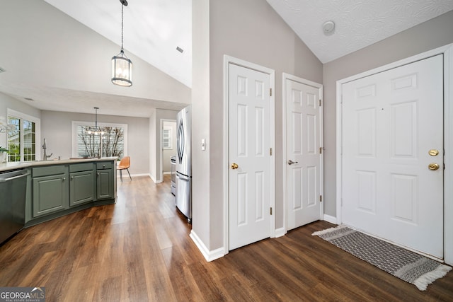 455 Ellesmere Way, Buford, GA 30518 - entrance foyer with dark wood-style floors, lofted ceiling, a chandelier, and baseboards