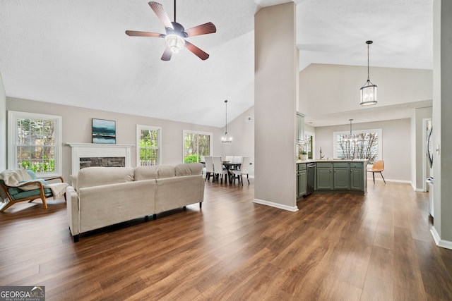 455 Ellesmere Way, Buford, GA 30518 - living room with dark wood finished floors, ceiling fan with notable chandelier, a fireplace, and a healthy amount of sunlight