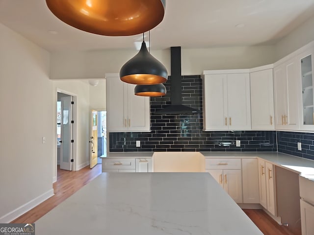 721 Cascade Ave SW, Atlanta, GA 30310 - kitchen with wall chimney exhaust hood, backsplash, wood finished floors, and white cabinets