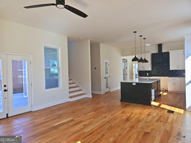 721 Cascade Ave SW, Atlanta, GA 30310 - kitchen featuring a center island, ceiling fan, backsplash, light wood-type flooring, and decorative light fixtures