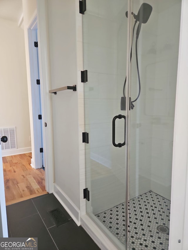 721 Cascade Ave SW, Atlanta, GA 30310 - full bathroom with a shower stall and tile patterned flooring