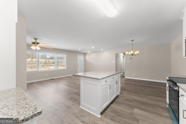kitchen with open floor plan, white cabinets, range with electric cooktop, and wood finished floors