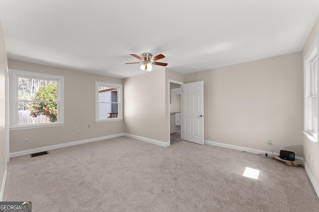 unfurnished bedroom featuring baseboards, a ceiling fan, visible vents, and carpet