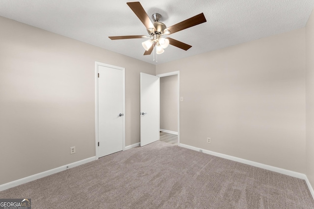 unfurnished bedroom featuring baseboards, carpet flooring, and ceiling fan