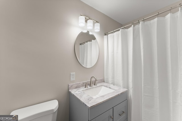 bathroom featuring toilet and vanity
