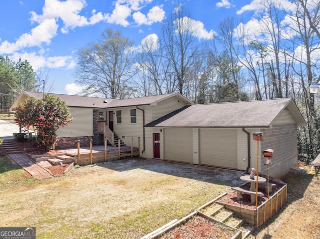 view of front of property featuring driveway, a shingled roof, and a garage