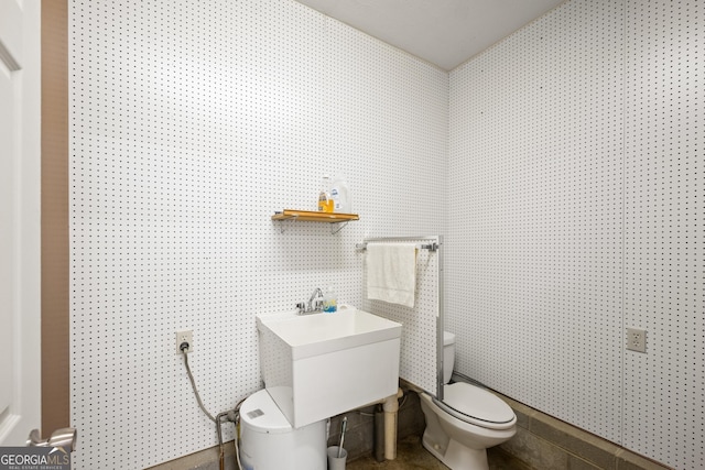 half bathroom with toilet and a sink
