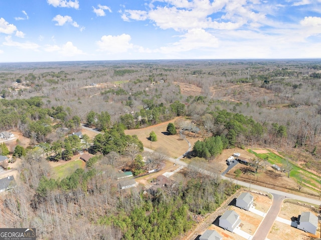 aerial view featuring a wooded view