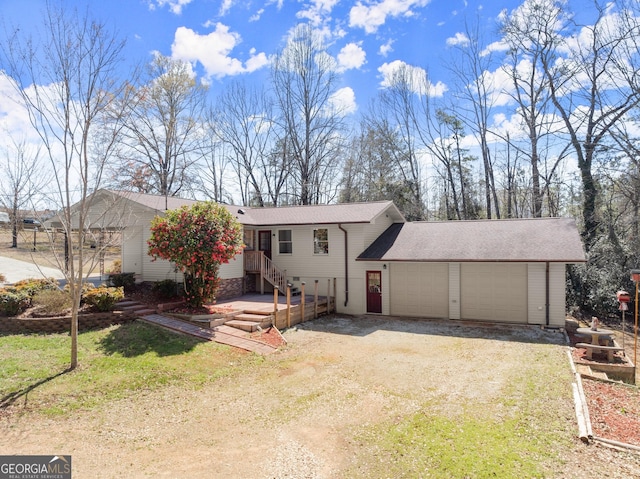 view of front of home featuring an attached garage, a shingled roof, and driveway