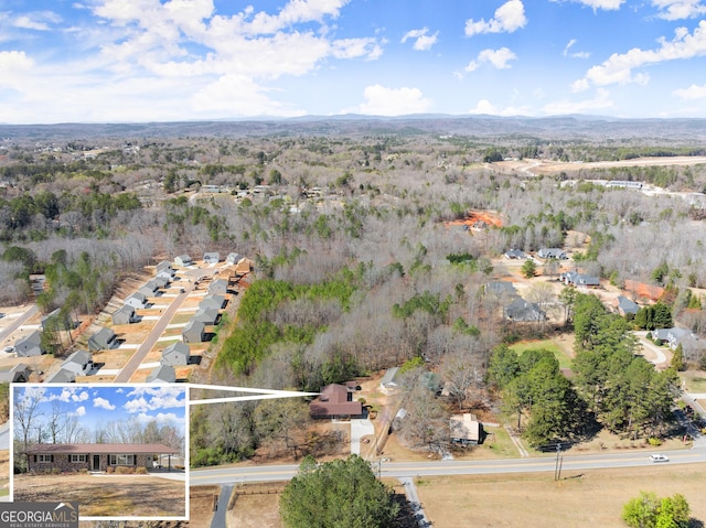 birds eye view of property with a wooded view