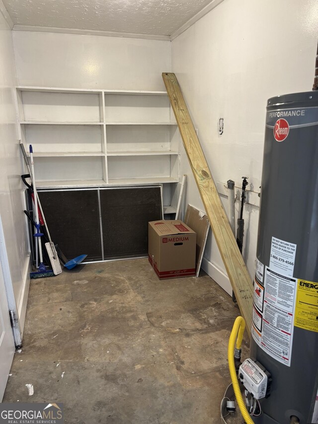 basement with water heater and a textured ceiling