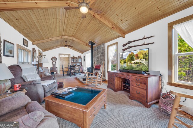181 Yonah Lake Cir, Toccoa, GA 30577 - living room featuring a ceiling fan, a wood stove, wood ceiling, an office area, and light colored carpet