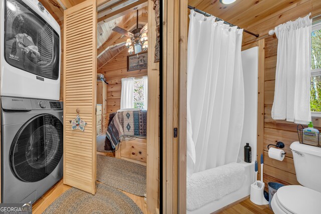 181 Yonah Lake Cir, Toccoa, GA 30577 - full bathroom featuring estacked washer and dryer, healthy amount of natural light, toilet, ensuite bath, and wood walls