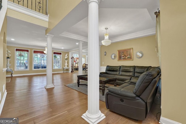 1621 Telfair Chase Way, Lawrenceville, GA 30043 - living room featuring crown molding, decorative columns, recessed lighting, and light wood-style floors