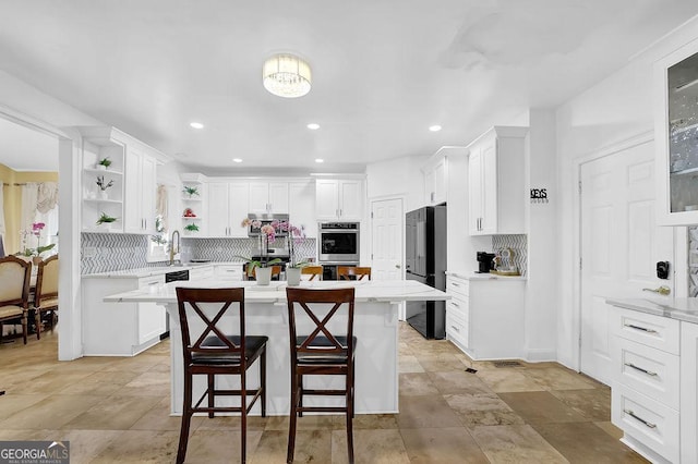 1621 Telfair Chase Way, Lawrenceville, GA 30043 - kitchen with tasteful backsplash, light countertops, open shelves, white cabinets, and a breakfast bar area