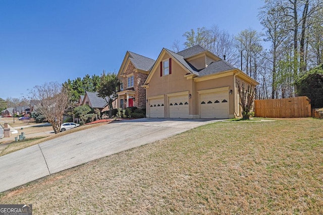 1621 Telfair Chase Way, Lawrenceville, GA 30043 - view of front of home featuring stucco siding, roof with shingles, a front yard, fence, and concrete driveway