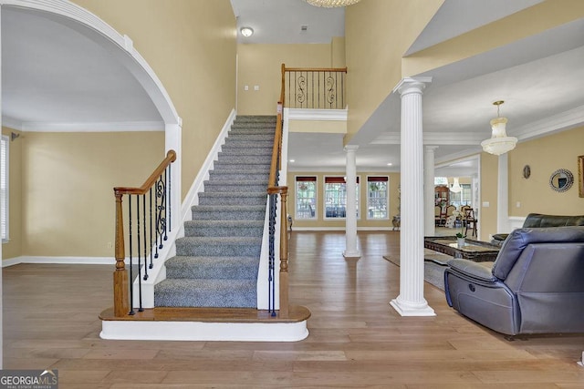 1621 Telfair Chase Way, Lawrenceville, GA 30043 - stairway with crown molding, decorative columns, and wood finished floors