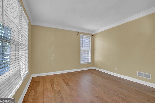 1621 Telfair Chase Way, Lawrenceville, GA 30043 - empty room with baseboards, crown molding, wood-type flooring, and visible vents