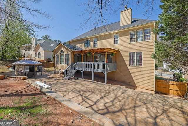 1621 Telfair Chase Way, Lawrenceville, GA 30043 - rear view of house featuring fence, a patio area, a wooden deck, and a chimney