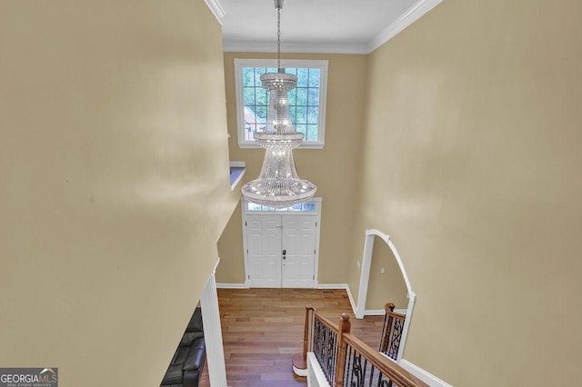 1621 Telfair Chase Way, Lawrenceville, GA 30043 - entrance foyer with a chandelier, wood finished floors, baseboards, and ornamental molding