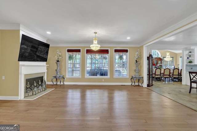 1621 Telfair Chase Way, Lawrenceville, GA 30043 - living room with crown molding, a chandelier, and wood finished floors