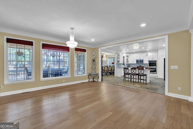 1621 Telfair Chase Way, Lawrenceville, GA 30043 - living area with baseboards, a chandelier, crown molding, visible vents, and wood finished floors