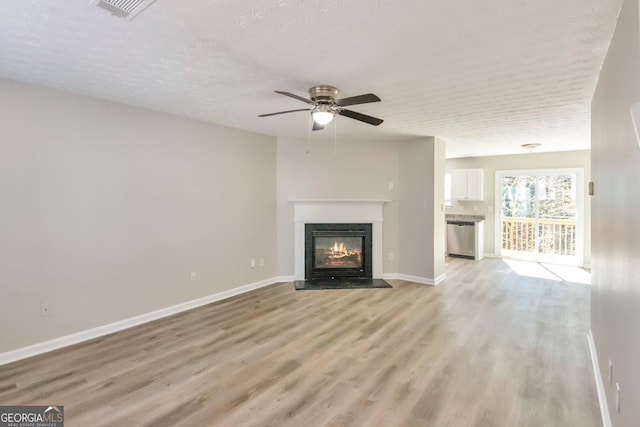 344 Springbottom Ct, Lawrenceville, GA 30046 - unfurnished living room featuring a fireplace with flush hearth, visible vents, baseboards, ceiling fan, and light wood-style floors