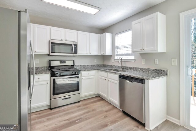 344 Springbottom Ct, Lawrenceville, GA 30046 - kitchen featuring white cabinetry, a sink, appliances with stainless steel finishes, and light stone counters