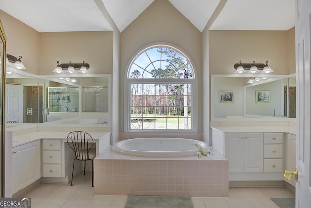 full bath featuring tile patterned flooring, a shower stall, vaulted ceiling, a bath, and vanity