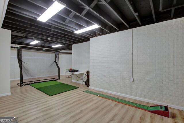 exercise room featuring wood finished floors