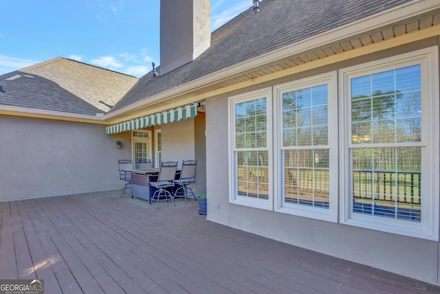 wooden terrace featuring outdoor dining area