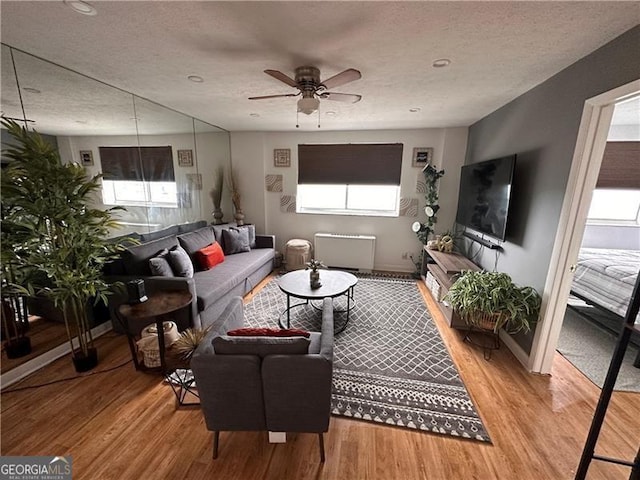 215 Piedmont Ave NE Unit 2205, Atlanta, GA 30308 - living room featuring light wood finished floors, a textured ceiling, and a ceiling fan