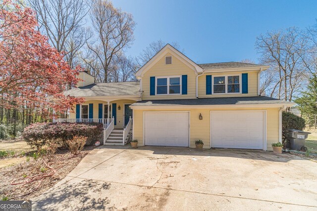 45 Somerset Ct, Covington, GA 30016 - view of front facade featuring covered porch, driveway, a garage, and a chimney