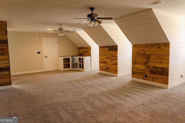 430 Brantley Rdg, Warner Robins, GA 31088 - additional living space with wood walls, ceiling fan, a textured ceiling, lofted ceiling, and carpet