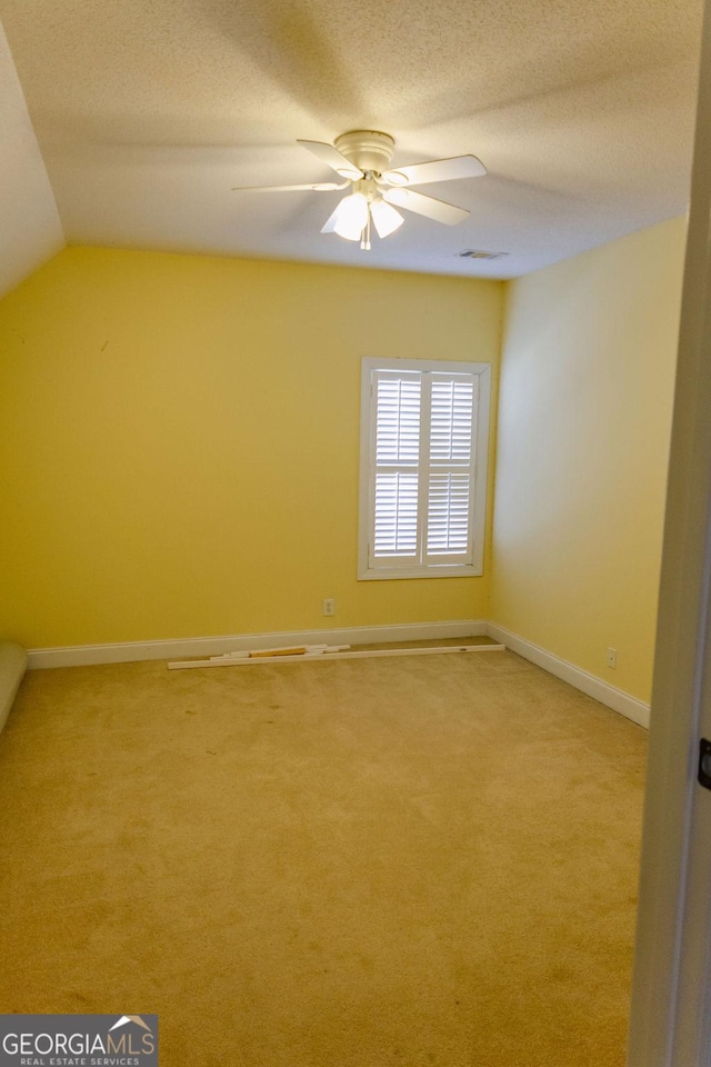 430 Brantley Rdg, Warner Robins, GA 31088 - unfurnished room with light colored carpet, ceiling fan, lofted ceiling, and a textured ceiling