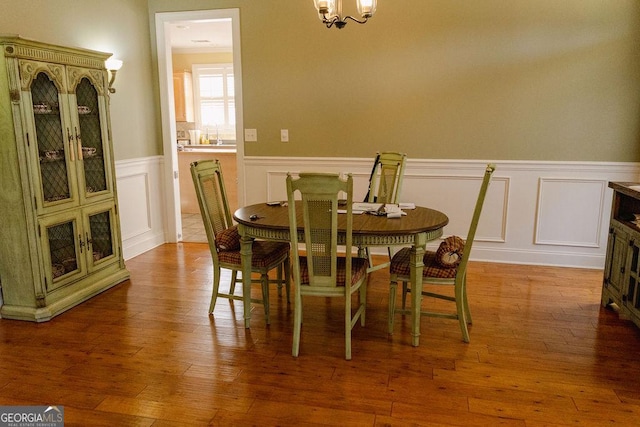 430 Brantley Rdg, Warner Robins, GA 31088 - dining room featuring a wainscoted wall, hardwood / wood-style floors, a decorative wall, and a chandelier