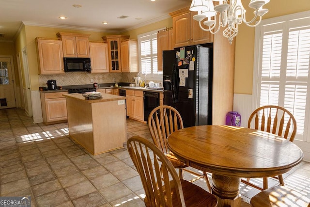 430 Brantley Rdg, Warner Robins, GA 31088 - kitchen with black appliances, light brown cabinetry, a kitchen island, tasteful backsplash, and a chandelier
