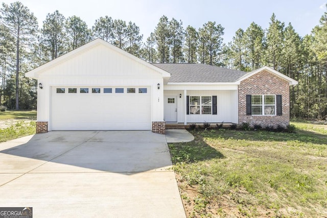ranch-style house with an attached garage, concrete driveway, a front lawn, and brick siding