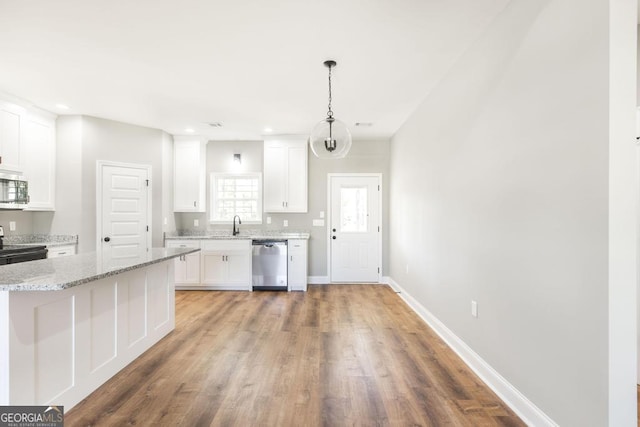 kitchen featuring appliances with stainless steel finishes, light wood-type flooring, baseboards, recessed lighting, and white cabinetry