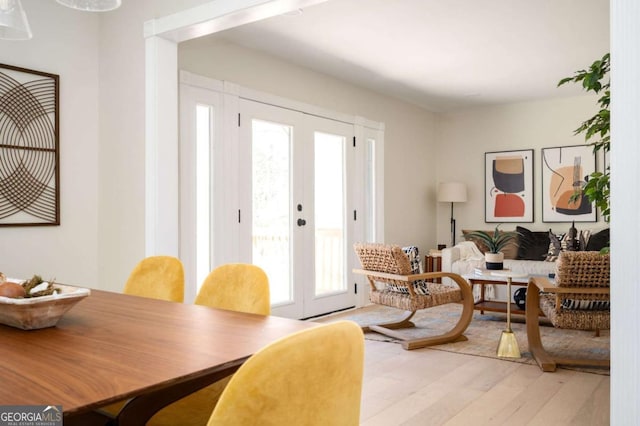 dining room with french doors and light wood finished floors