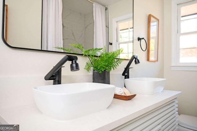 bathroom featuring toilet and vanity