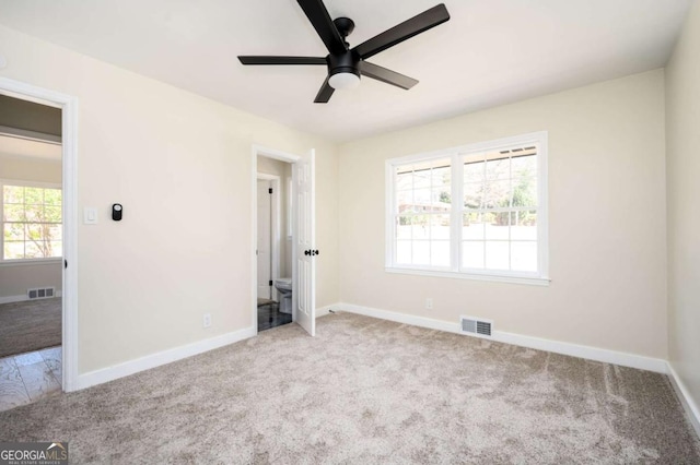 unfurnished bedroom with visible vents, carpet flooring, baseboards, and ceiling fan